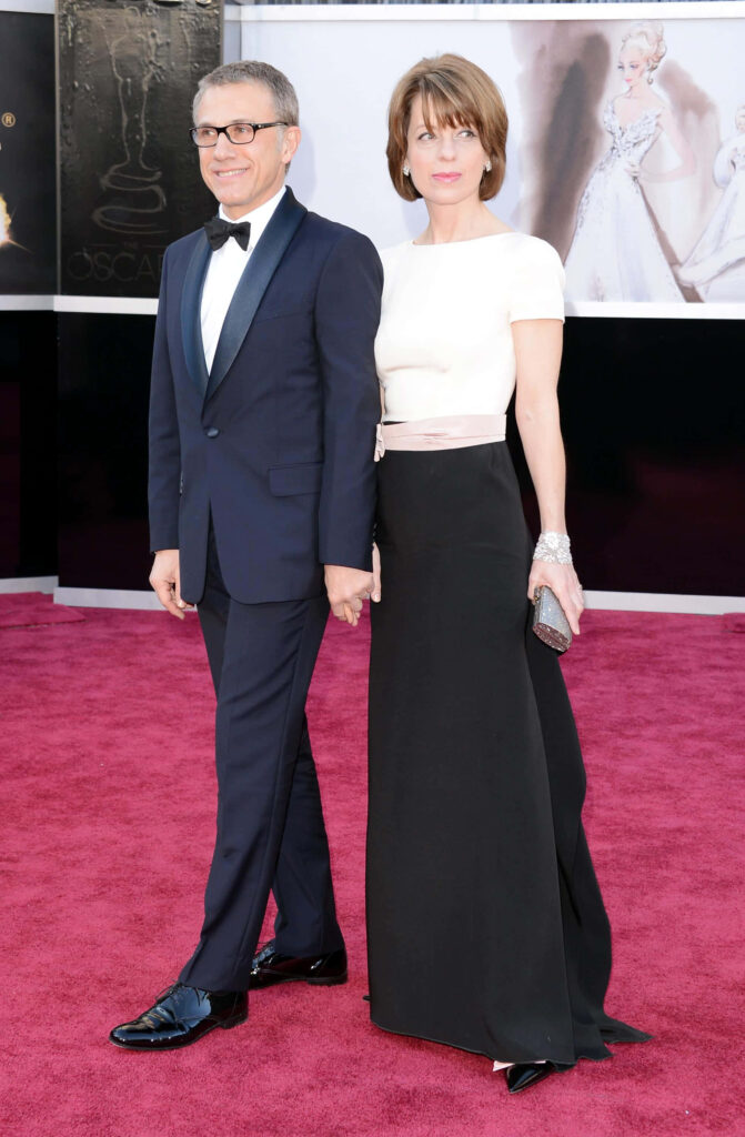 Christoph Waltz and wife Judith Holste pose elegantly on red carpet at 85th Academy Awards event Wallpaper