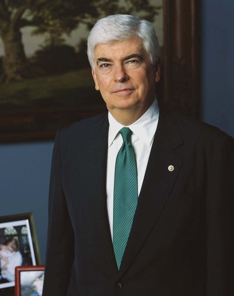 Portrait of former U.S. Senator Christopher Dodd in dark suit and green tie office setting Wallpaper