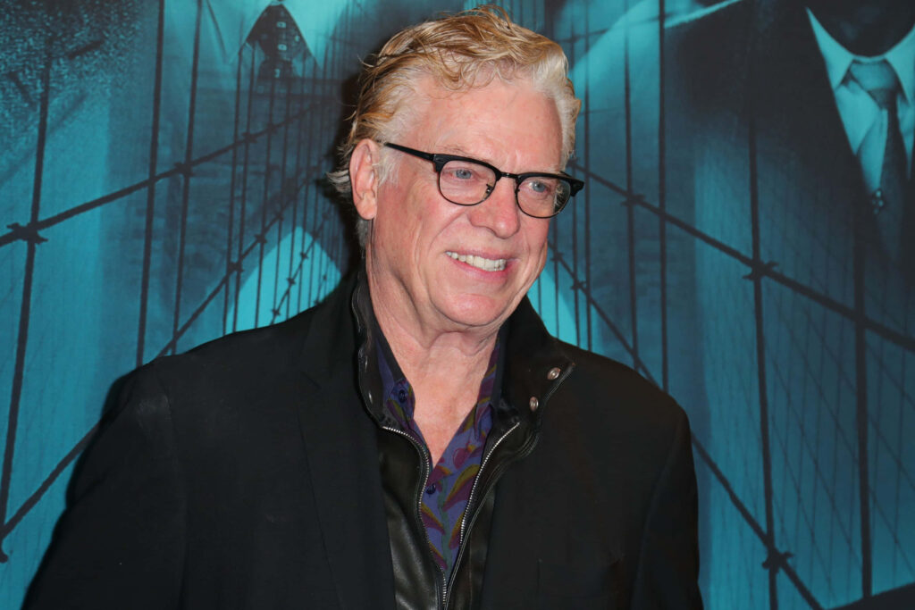 Christopher McDonald candid portrait with blue abstract bridge backdrop stylish black jacket Wallpaper