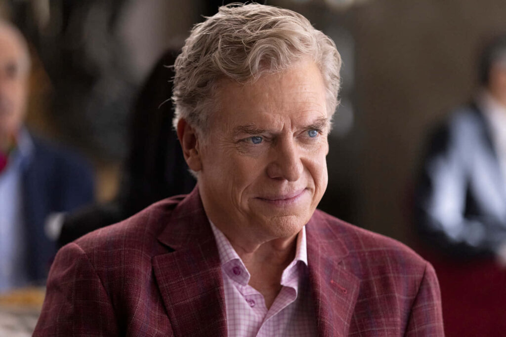 Christopher McDonald portrait in maroon checkered suit and pink shirt with natural lighting Wallpaper