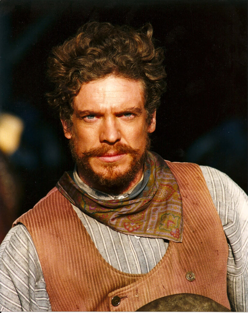 Christopher McDonald vintage cowboy wallpaper intense gaze brown vest paisley bandana background