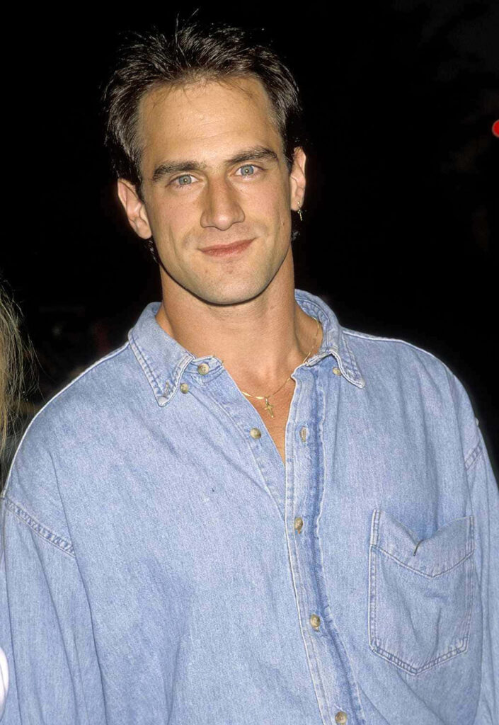 Christopher Meloni in light blue denim shirt with confident expression casual wallpaper background