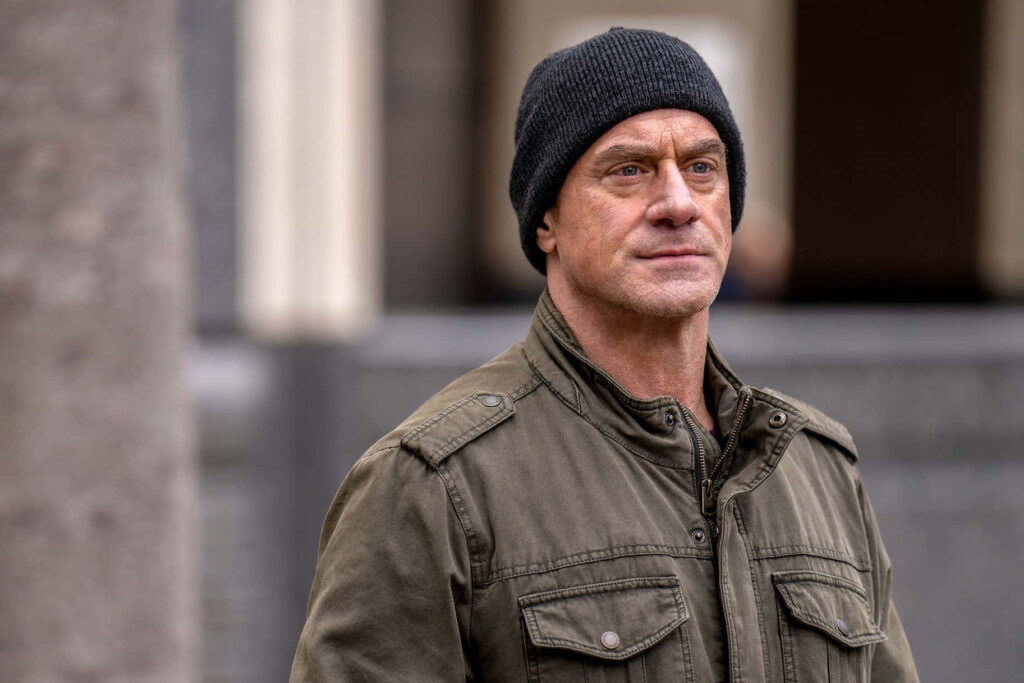 Christopher Meloni in dark beanie and military jacket urban background intense cinematic wallpaper