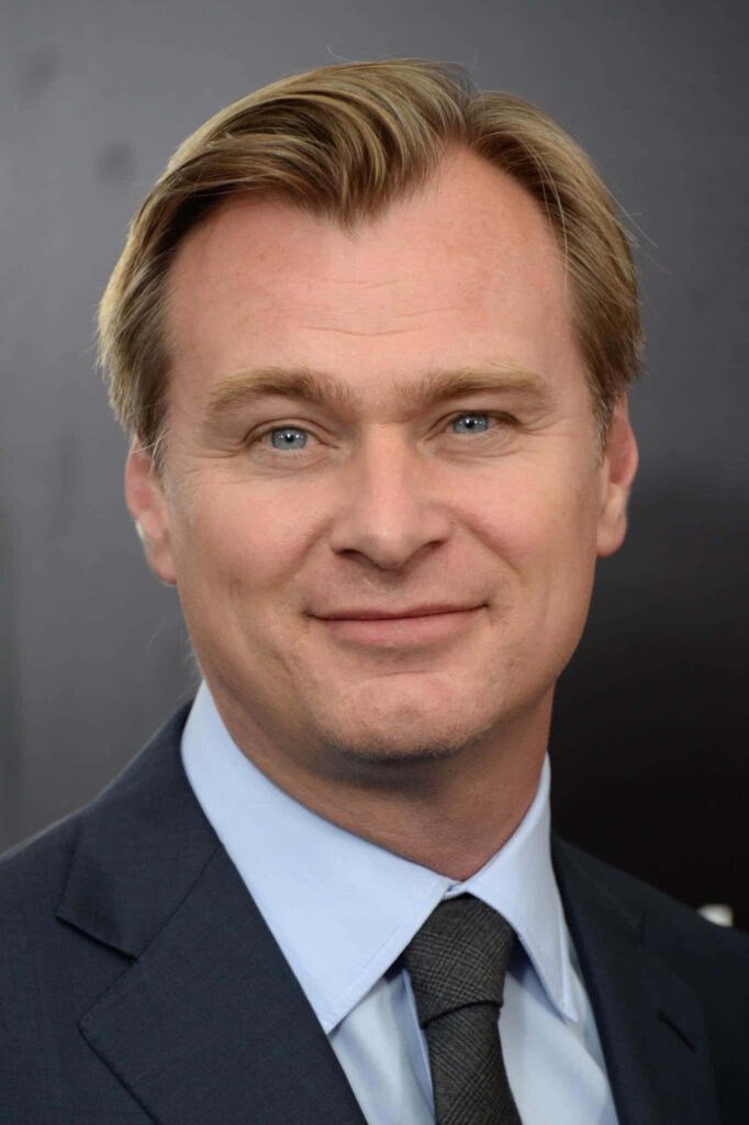 Christopher Nolan portrait in suit and tie with calm expression and dark blurred background Wallpaper