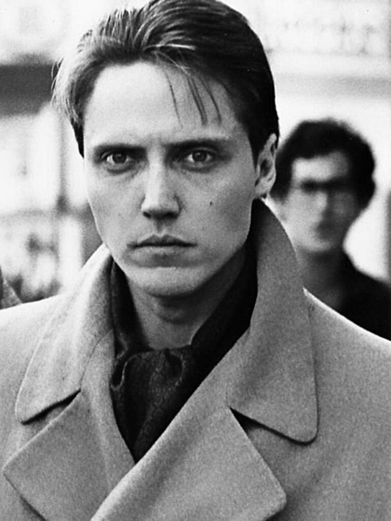 Greyscale portrait of middle-aged Christopher Walken with intense gaze and dramatic shadows wallpaper