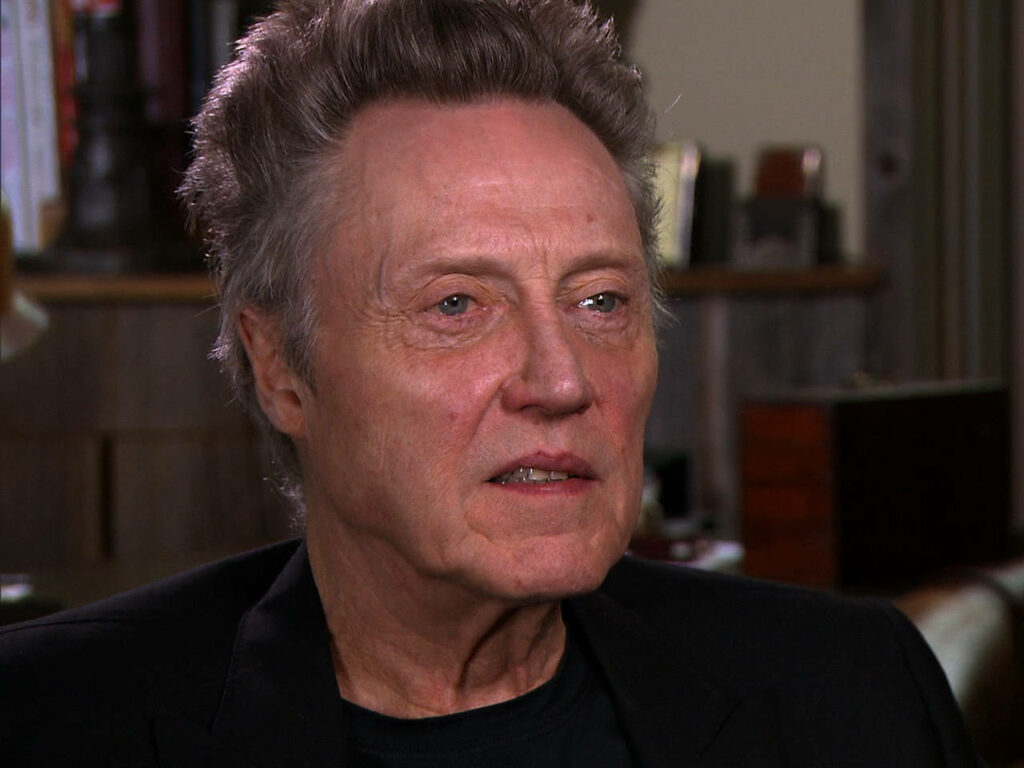 Christopher Walken candid interview warm lighting cozy wood room expressive face wallpaper