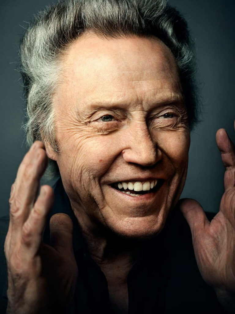 Christopher Walken laughing close-up with silver hair expressive eyes dark background wallpaper