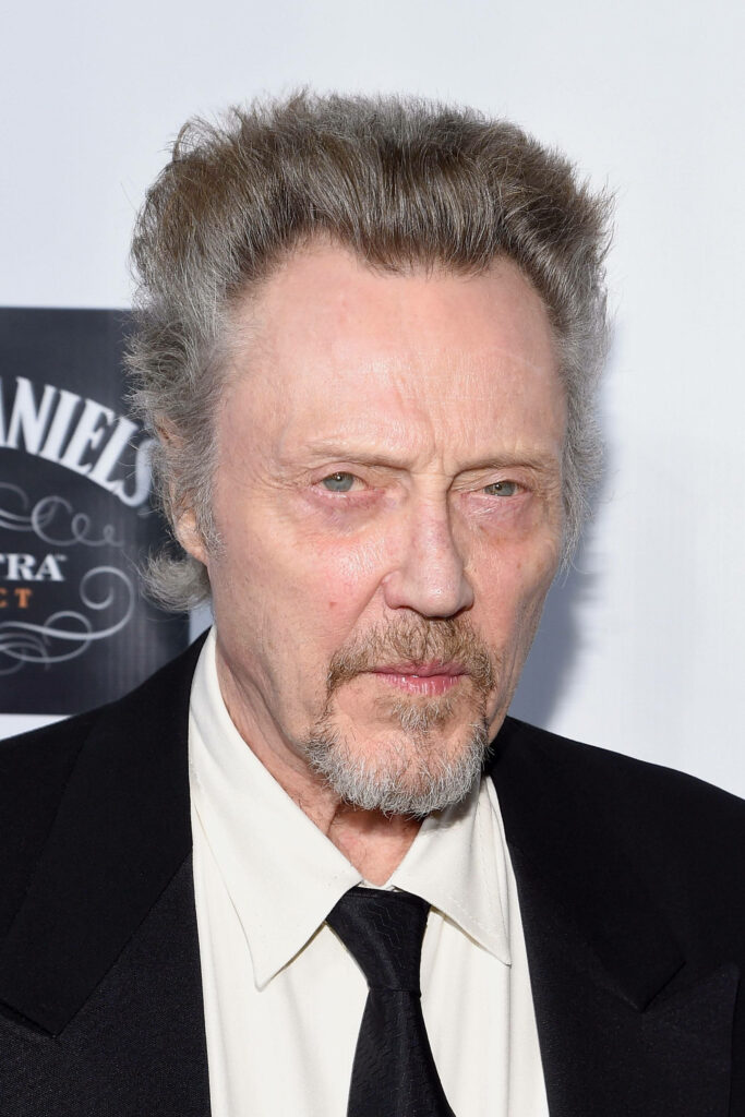 Christopher Walken in sharp black suit on Hollywood stage intense gaze classic wallpaper background