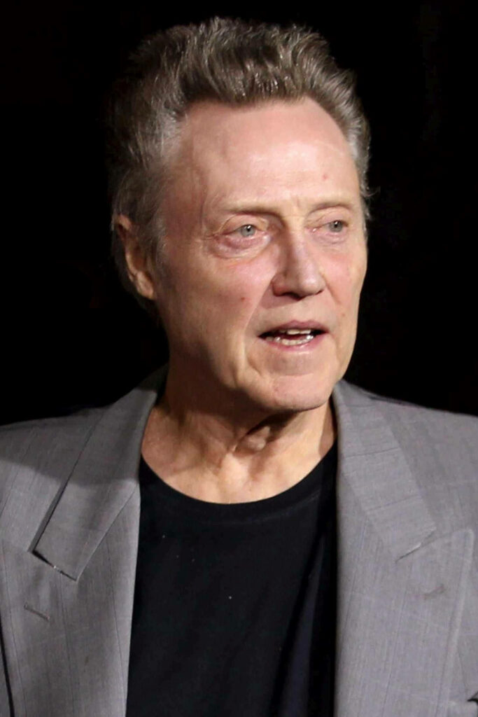 Christopher Walken portrait wallpaper indoor light gray blazer black shirt dark background