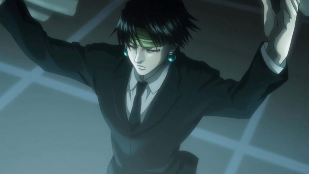 Chrollo Lucilfer in dim room with blue tones plotting strategy intense thoughtful pose wallpaper