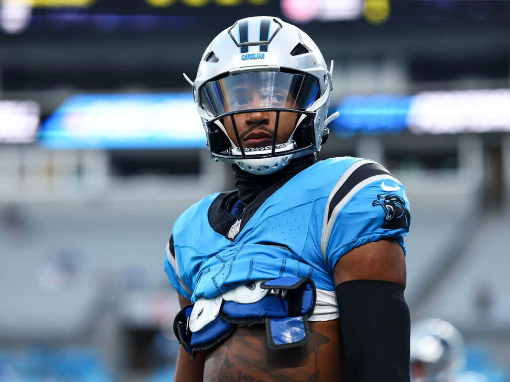 Chuba Hubbard focused in Carolina Panthers uniform before game with vibrant blue and black gear Wallpaper