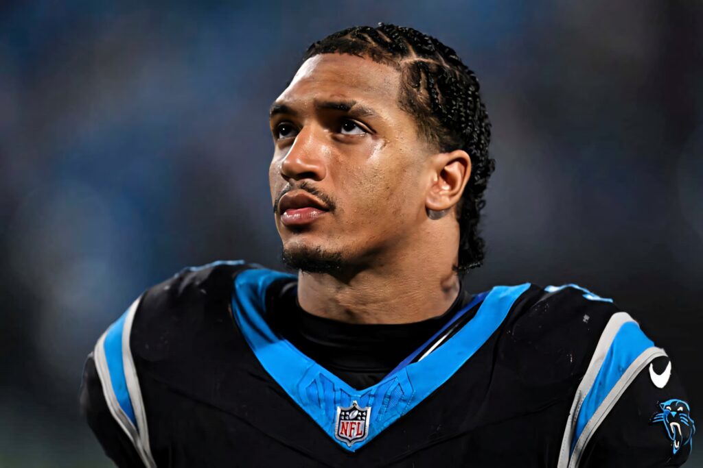 Chuba Hubbard focused portrait in Carolina Panthers uniform bold blue black stadium background Wallpaper