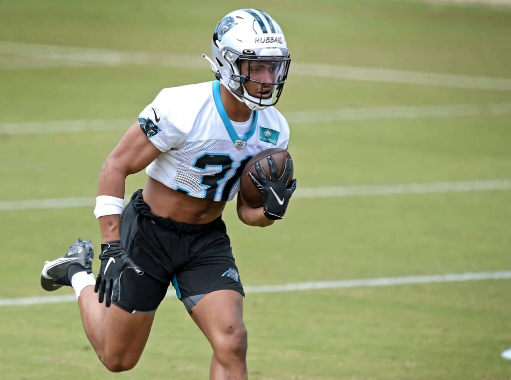 Chuba Hubbard sprinting during Carolina Panthers training drill showing focus athleticism and speed Wallpaper