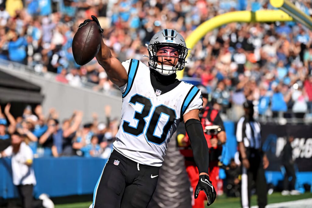 Chuba Hubbard Carolina Panthers touchdown celebration mid-action vibrant football stadium wallpaper