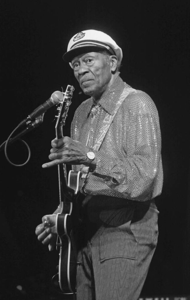Chuck Berry live rock and roll performance black and white wallpaper with captain’s cap