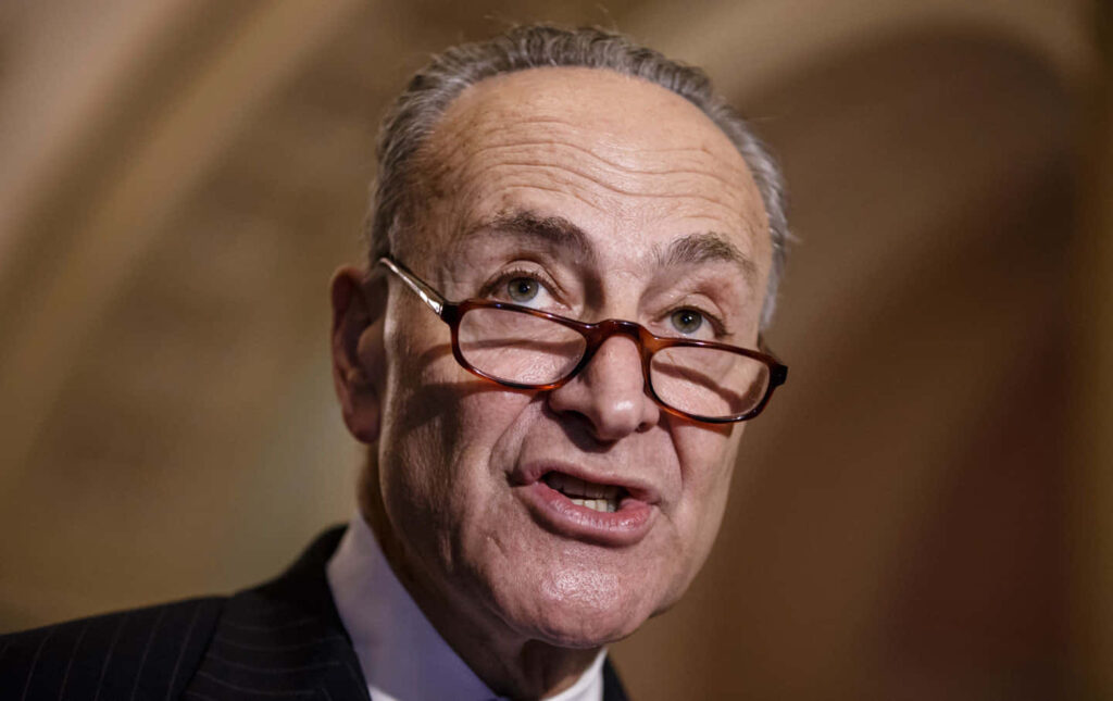 Close-up portrait of Chuck Schumer U.S Senate leader with warm lighting and blurred background Wallpaper