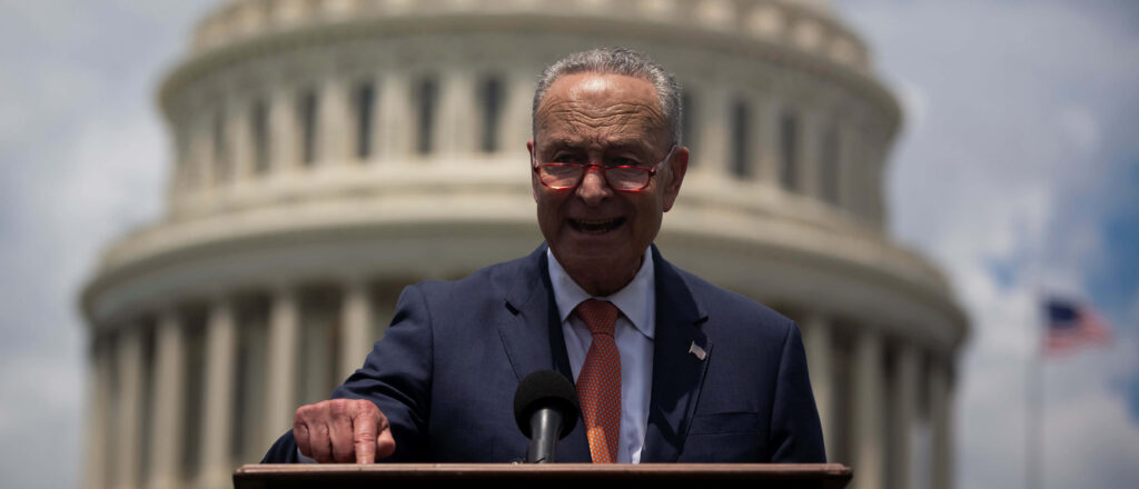 Chuck Schumer speaking at U.S. Capitol dome serious leadership governance wallpaper background
