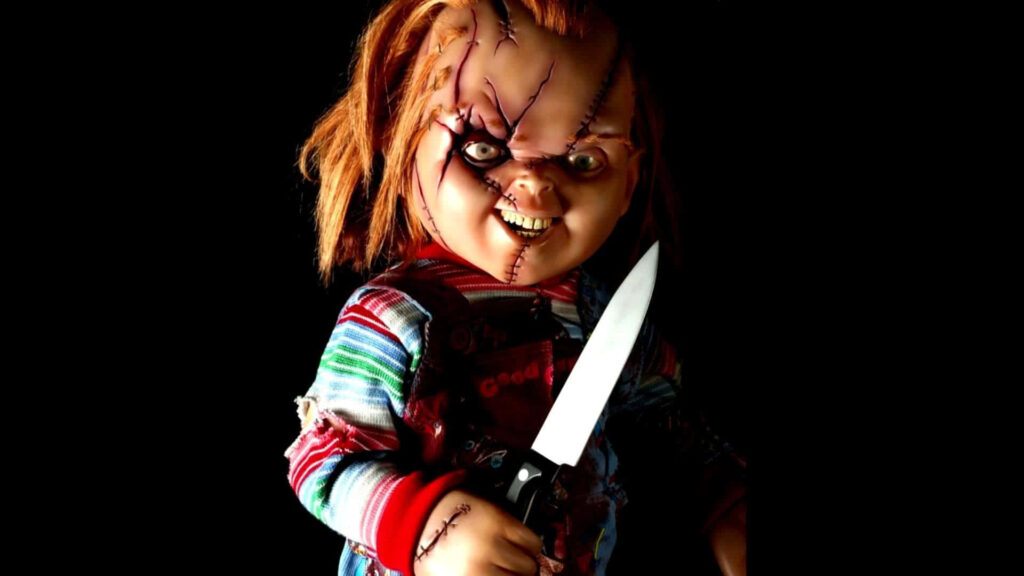 Menacing Chucky Doll: Red-haired Horror Icon Stares into Your Soul Wallpaper