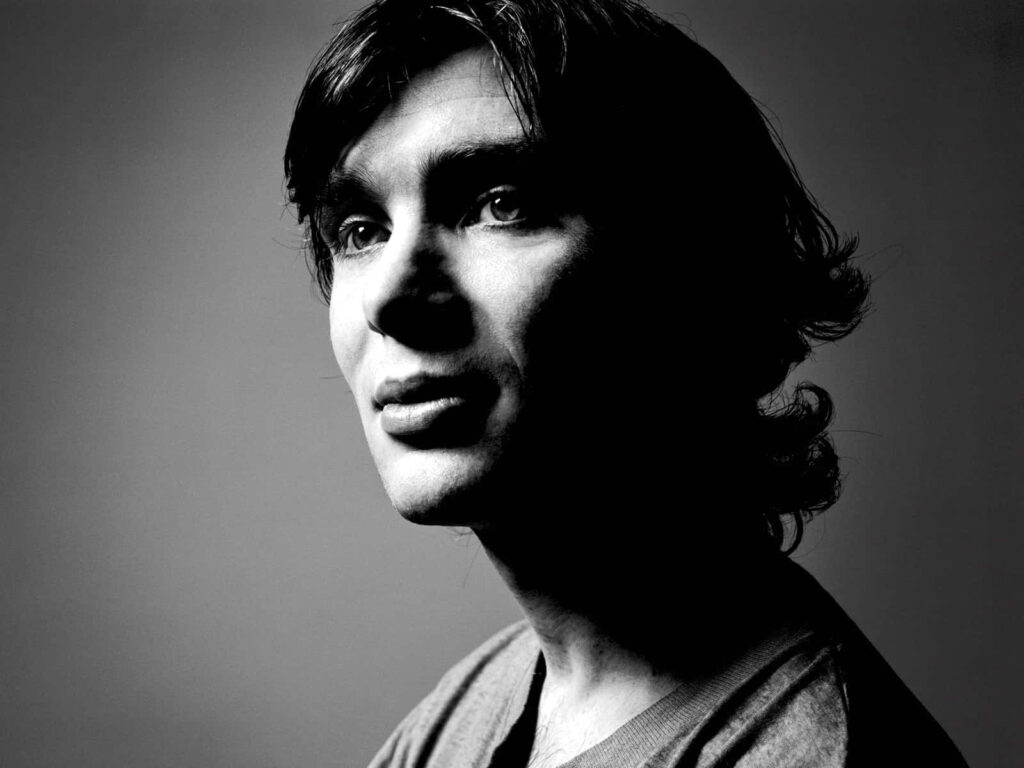 Black and white wallpaper of Cillian Murphy portrait with dramatic lighting and sharp facial features