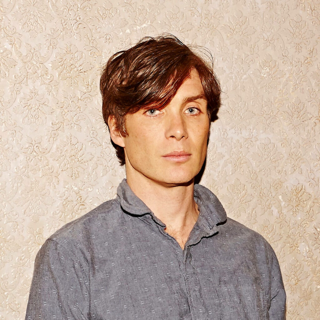 Cillian Murphy casual grey shirt minimalist portrait against light patterned wall wallpaper background