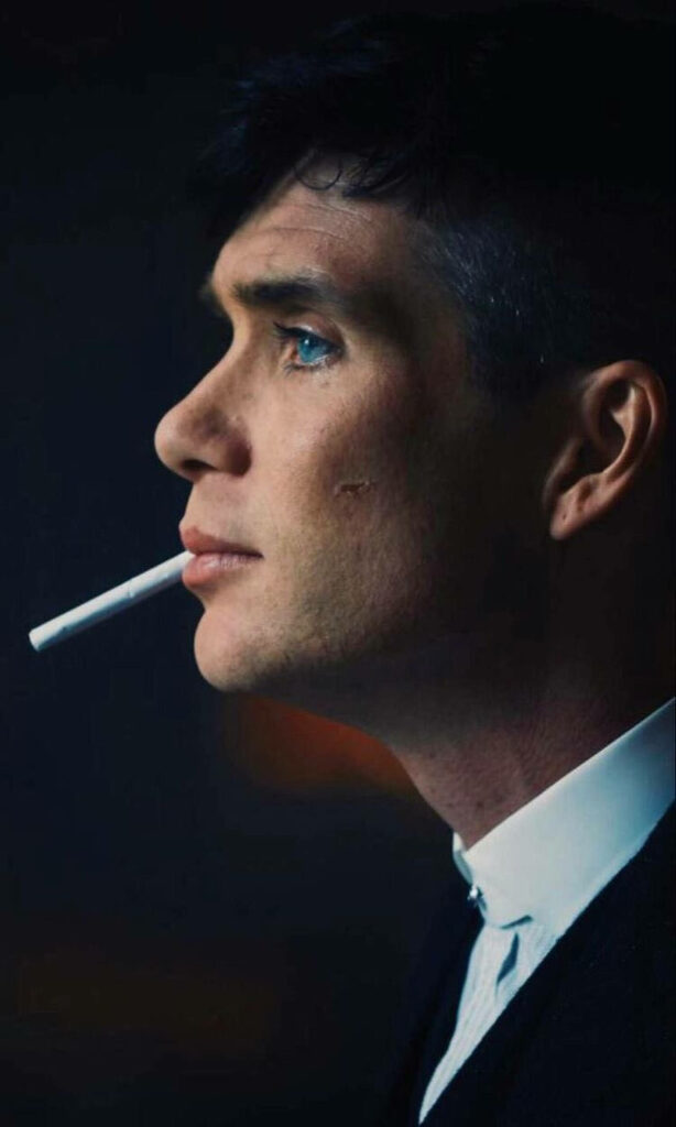 Cillian Murphy as Tommy with focused expression smoking cigarette dramatic side view wallpaper