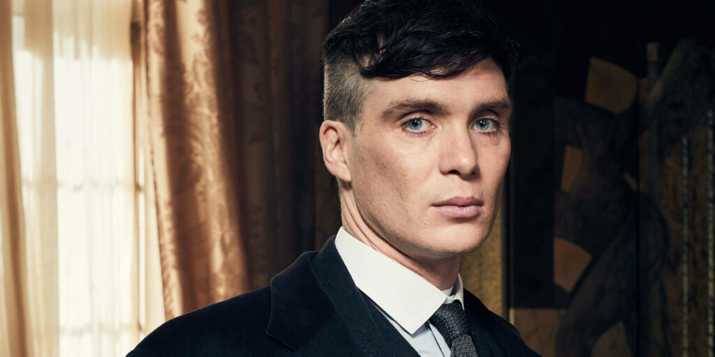 Closeup of Cillian Murphy as Tommy with intense gaze and sharp features dramatic wallpaper