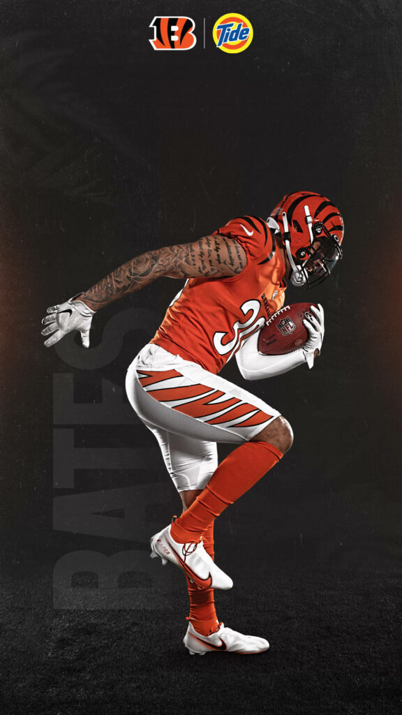 Cincinnati Bengals Jessie Bates in orange white uniform full game action dark textured background Wallpaper