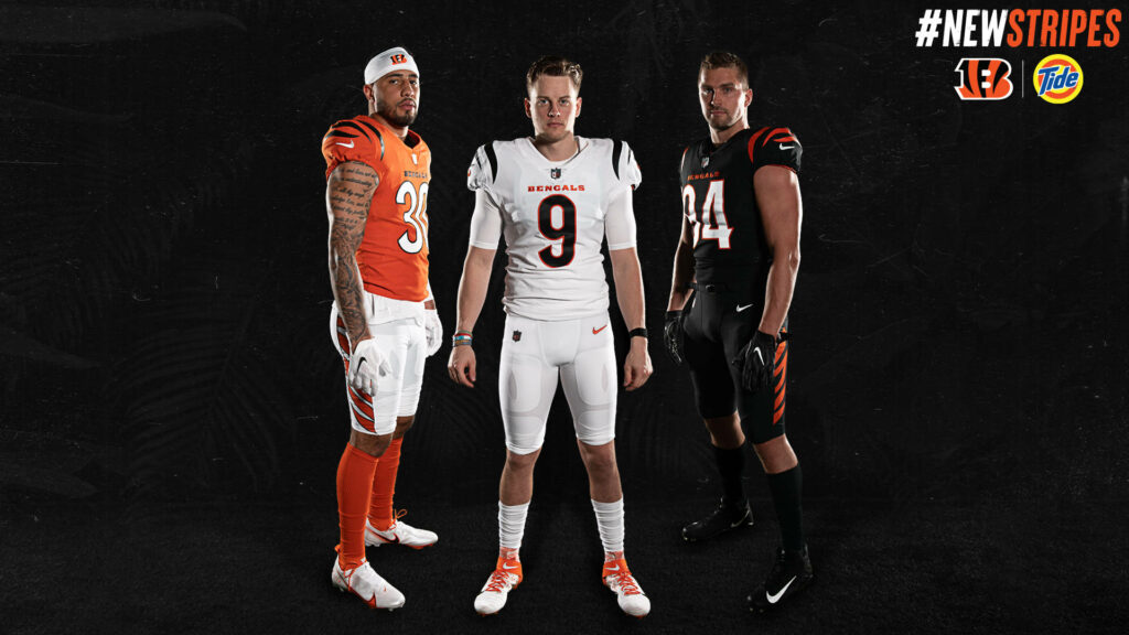 Cincinnati Bengals Joe Burrow and Sam Hubbard in bold uniforms on black background wallpaper