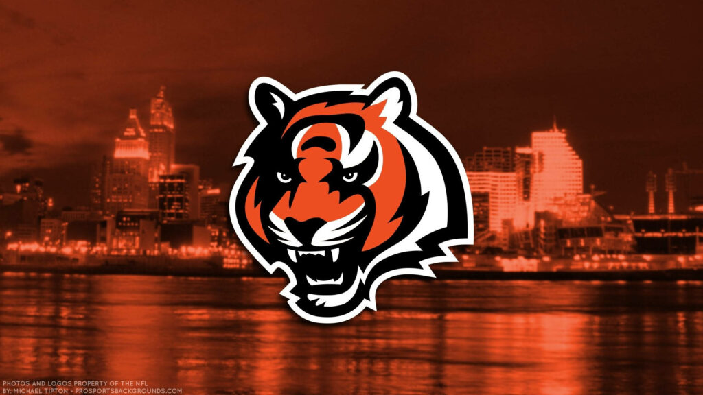 Cincinnati Bengals tiger logo over red cityscape background bold sports wallpaper design