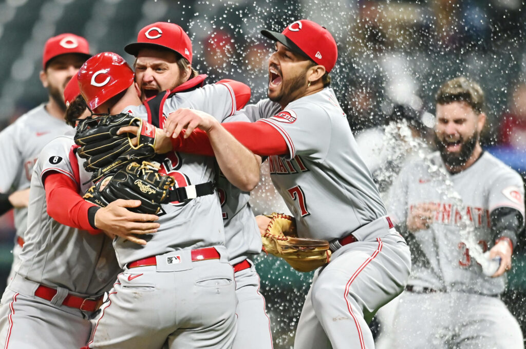 Cincinnati Reds players in gray red uniforms celebrate victory with water splashes and excitement Wallpaper