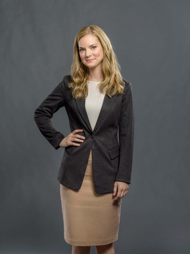 Cindy Busby in checked blazer beige skirt cream top confident professional portrait background Wallpaper