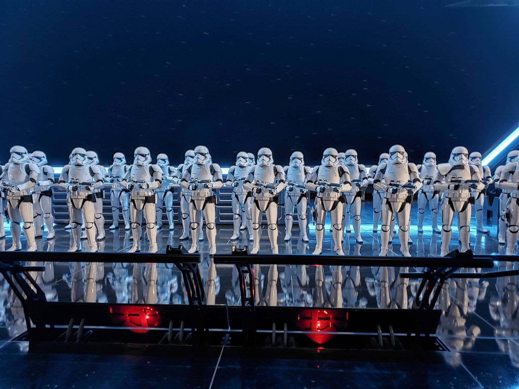First Order Stormtroopers lined up in dark futuristic ship with blue light reflecting armor Wallpaper