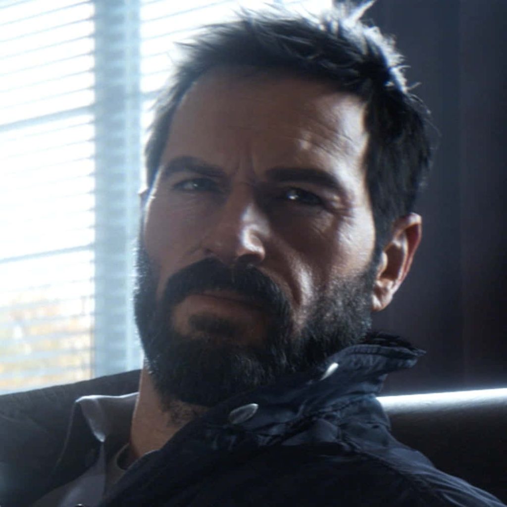 Cinematic close-up of intense tactical operator with dark beard and dramatic window blind lighting Wallpaper