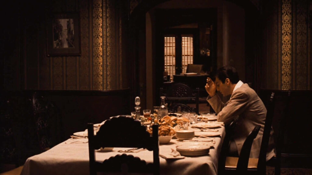 Cinematic Wallpaper: Michael Corleone at Dining Table - Moody Background