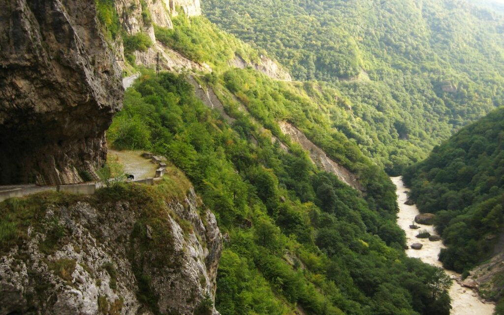 Circassian gorge Russia lush green mountains winding river rugged natural wilderness wallpaper