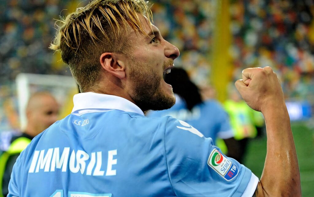 Ciro Immobile celebrating a powerful strike in vibrant stadium action high definition wallpaper