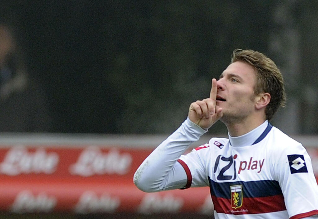Ciro Immobile celebrates goal in Genoa kit dynamic football wallpaper red blue white colors