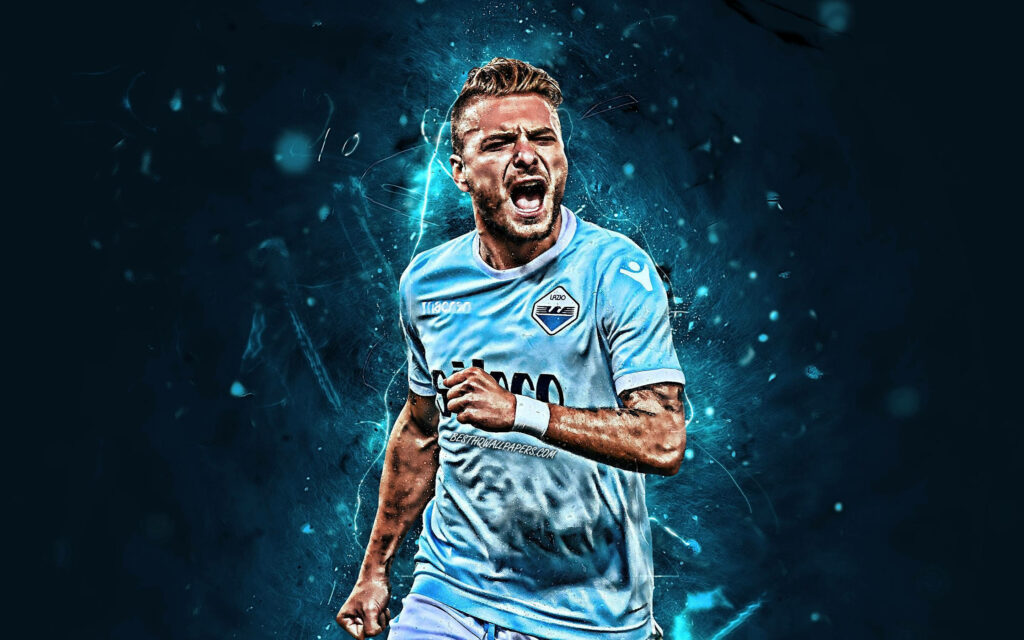 Ciro Immobile in Lazio kit dynamic action intense expression blue abstract background wallpaper