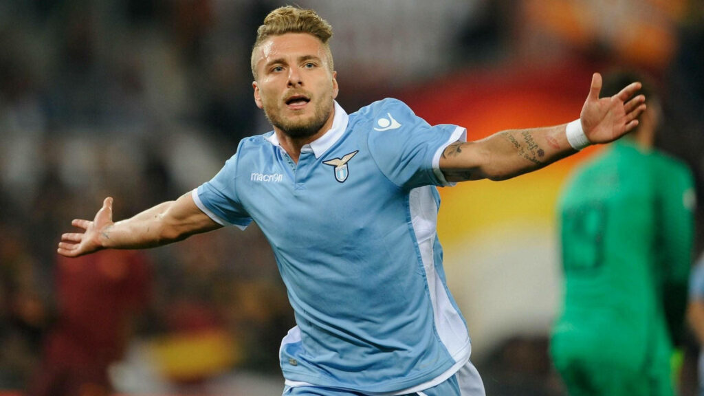 Ciro Immobile celebrating in Lazio kit close-up on soccer field vibrant blue white uniform wallpaper