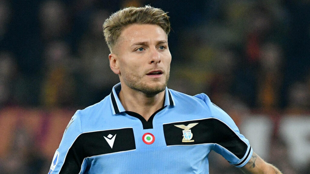 Close-up of Ciro Immobile in Lazio jersey showing focus and athleticism with stadium background Wallpaper