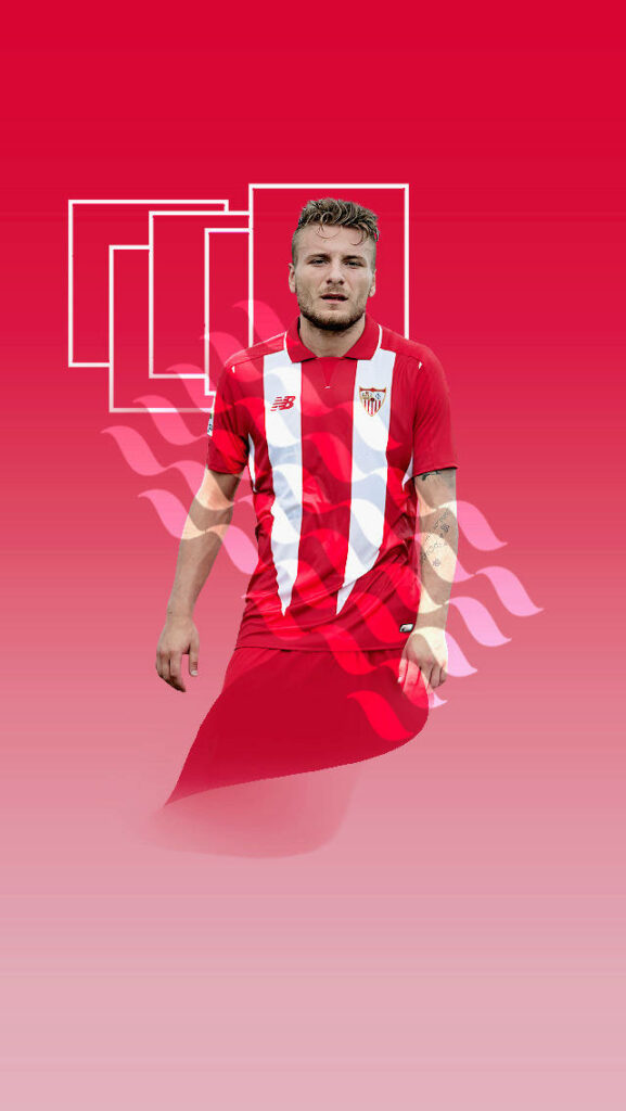 Ciro Immobile celebrating goal in Sevilla kit on bold red dynamic white graphic wallpaper background