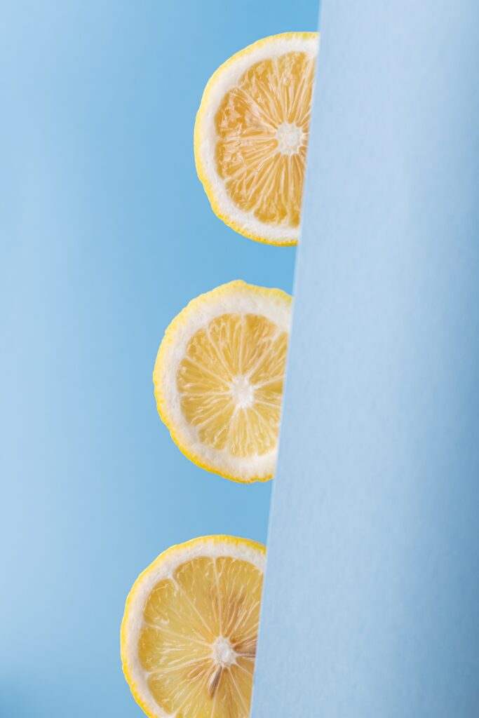Fresh Lemon Slices Wallpaper on Bright Blue Background