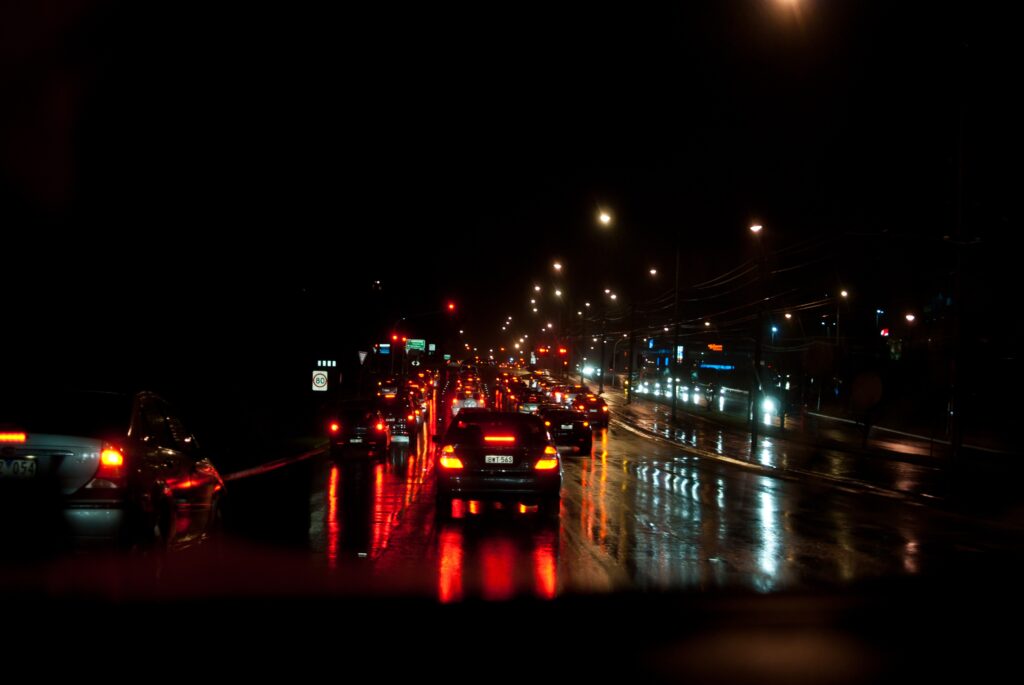 Vibrant Night Cityscape Wallpaper with Busy Traffic & Reflections