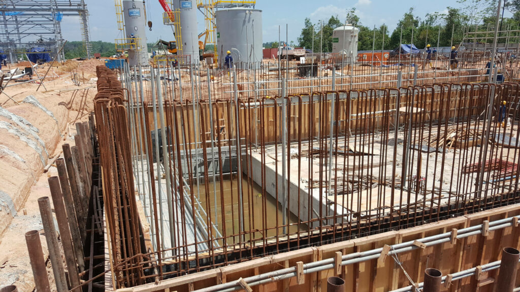 Construction site with reinforced concrete framework steel rebar and wooden formwork foundation pit Wallpaper