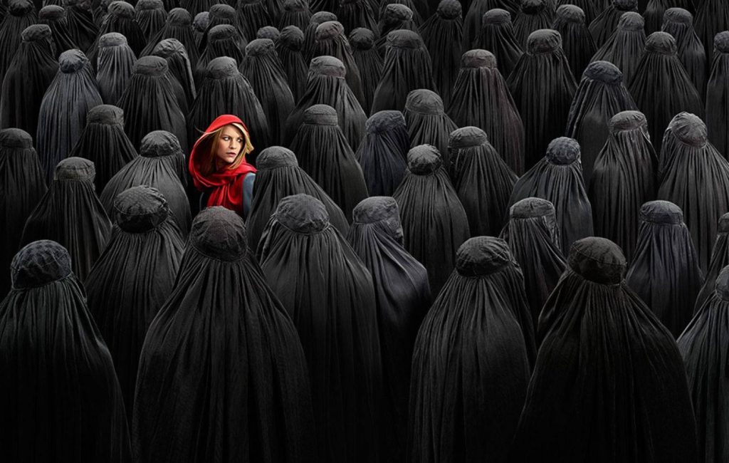 Claire Danes as Carrie Mathison in red headscarf contrasts black figures Homeland wallpaper