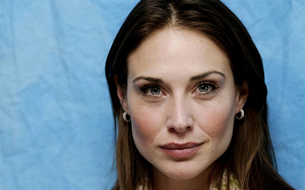 Claire Forlani close-up portrait with natural makeup soft lighting and serene blue background wallpaper
