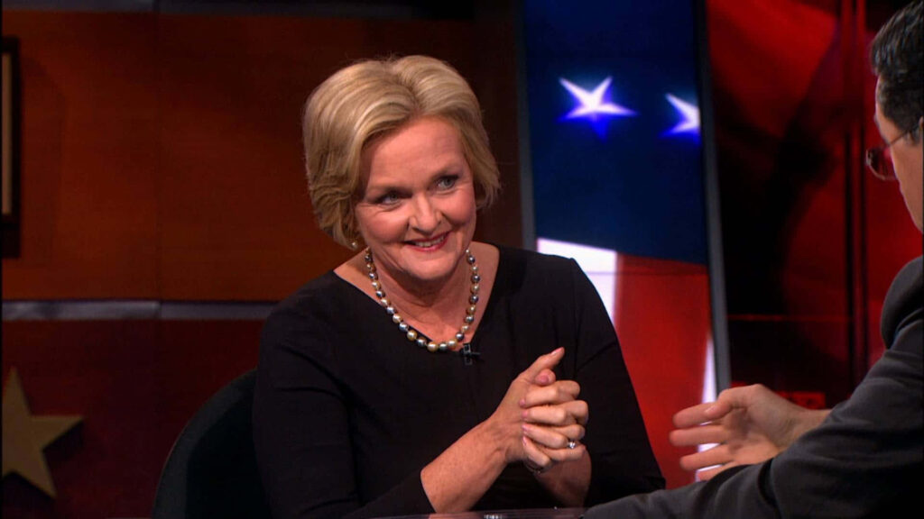 Claire McCaskill interviewed by Stephen Colbert with American flag stars and stripes backdrop Wallpaper