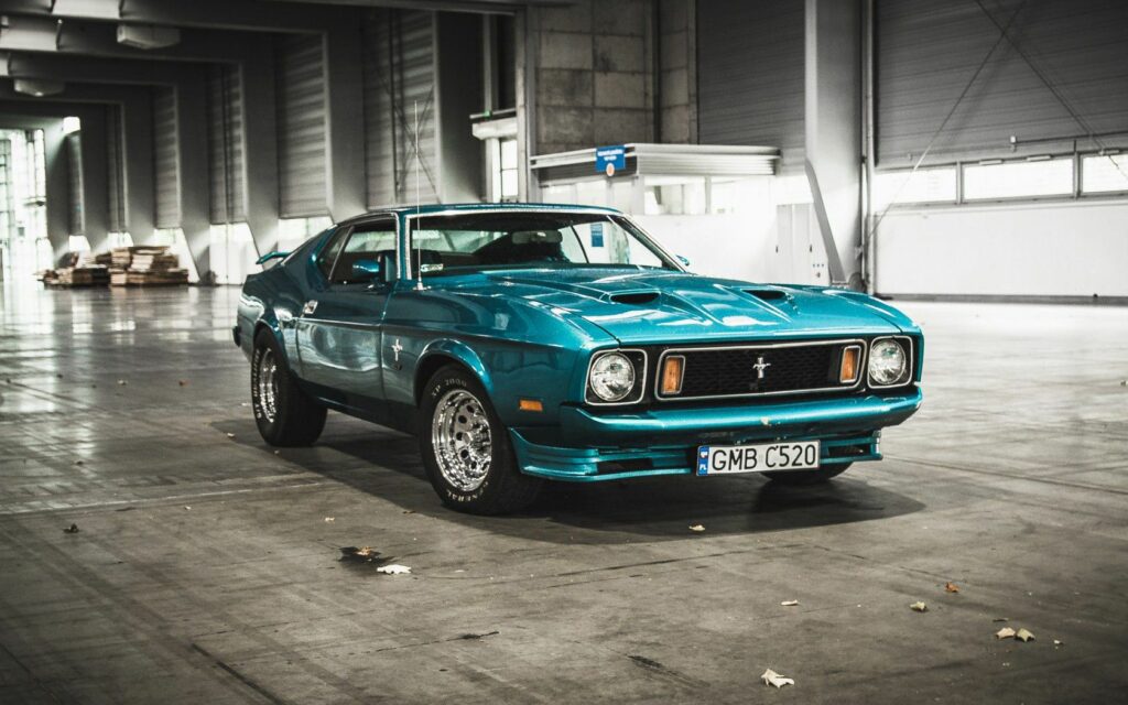 1973 Ford Mustang in Spacious Hangar: Classic Blue Wallpaper