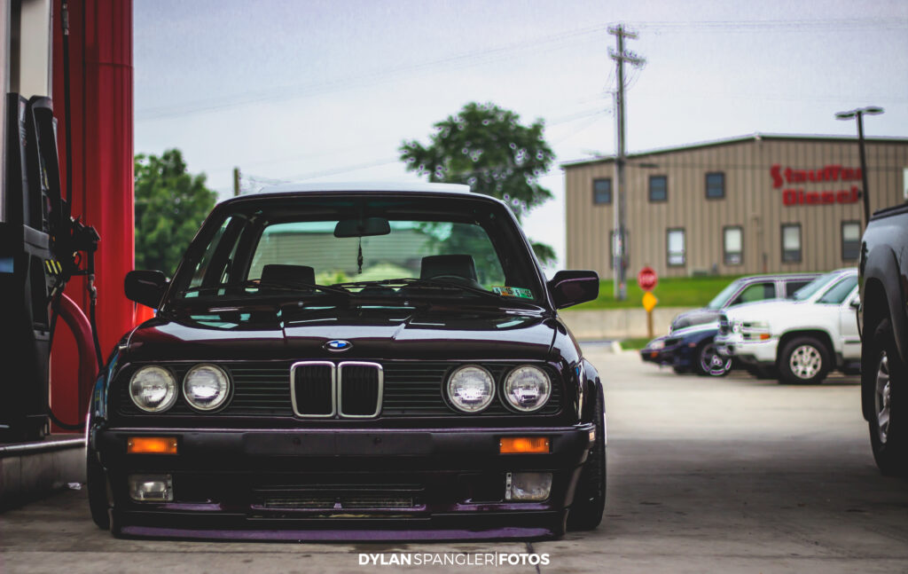 Classic BMW at Filling Station: Iconic Grille & Vintage Background Wallpaper