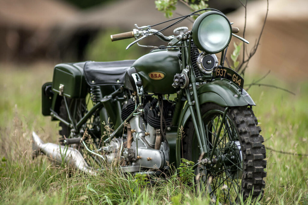 Classic BSA Bobber Motorcycle Wallpaper on Lush Green Grass